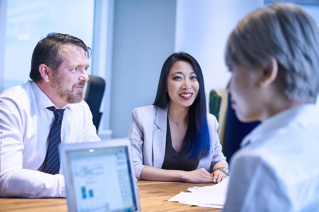 Advisors in conversation with a client across a table